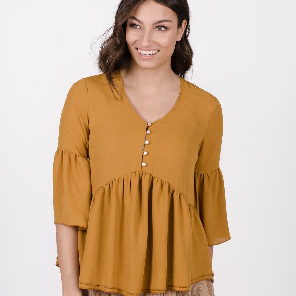 Loose yellow blouse with flared sleeves and V-neck